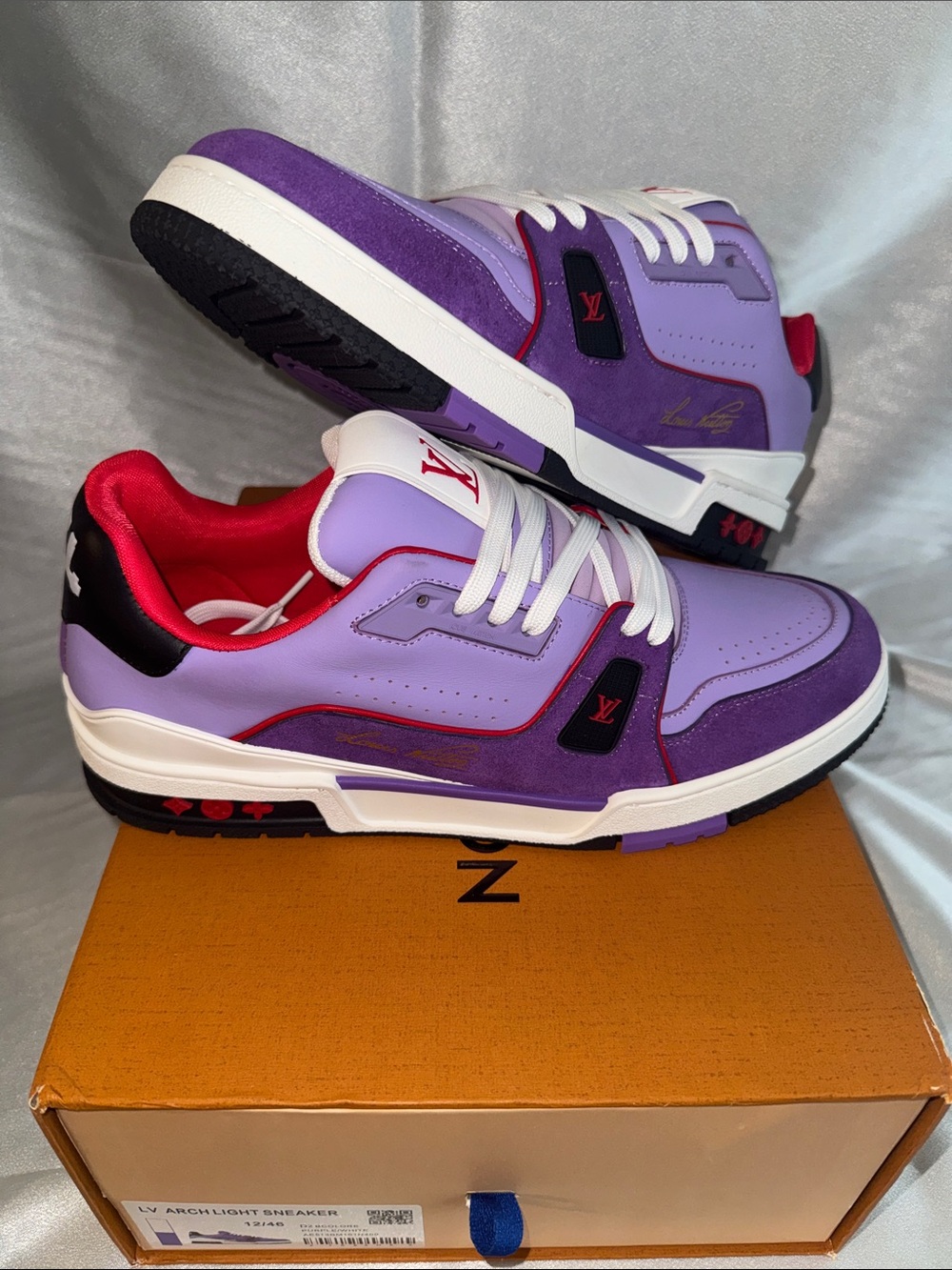 New! Louis Vuitton Trainer sneakers in a purple and red colorway.